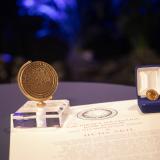 Gruber prize pin, paperweight and citation